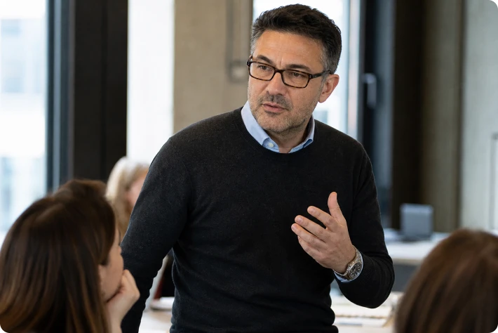 An advisor talking with a group of founders.